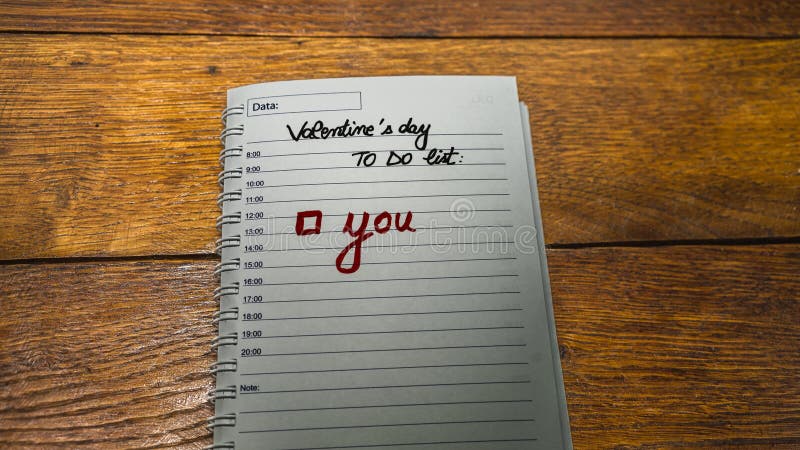 writing love text on paper, lovely message. Text on spiral agenda. Romantic, love concept. To do list for Valentine`s day. writing love text on paper, lovely message. Text on spiral agenda. Romantic, love concept. To do list for Valentine`s day