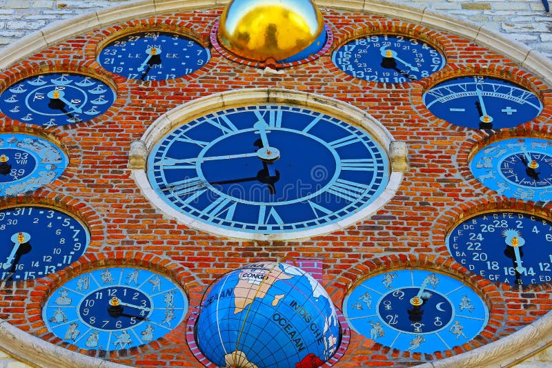 View on medieval tower with 12 clock faces showing metonic moon phases, time, periodic phenomena, solar cycle, tides, seasons