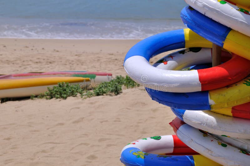 Life buoy and rubber boat on sea beach