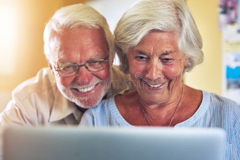 Life is so much simpler with technology in it. a senior couple using a laptop together at home. stock photos
