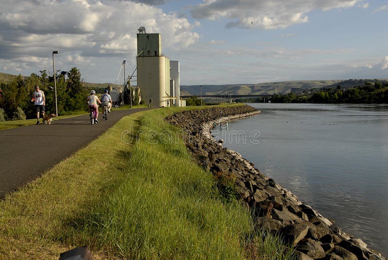 Lewiston /Idaho /USA- 25 May 2016_Life at Snake river Lewiston Levee ,people walking,walking wih dogs kids in river for coool off male hunting fish / Photo. Francis Joseph Dean / Deanpictures.