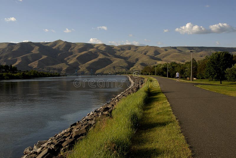 Lewiston /Idaho /USA- 25 May 2016_Life at Snake river Lewiston Levee ,people walking,walking wih dogs kids in river for coool off male hunting fish / Photo. Francis Joseph Dean / Deanpictures.