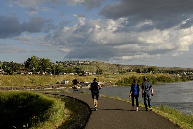 Lewiston /Idaho /USA- 25 May 2016_Life at Snake river Lewiston Levee ,people walking,walking wih dogs kids in river for coool off male hunting fish / Photo. Francis Joseph Dean / Deanpictures.