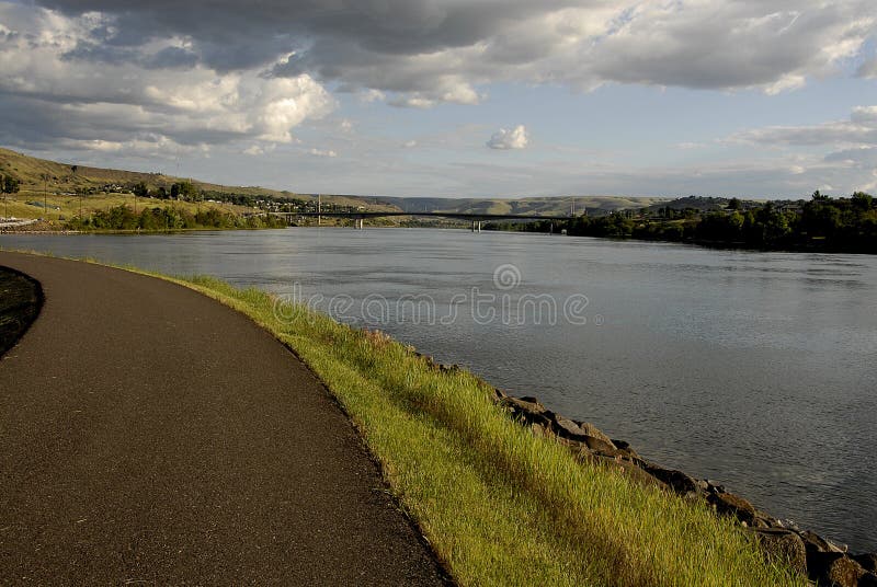 Lewiston /Idaho /USA- 25 May 2016_Life at Snake river Lewiston Levee ,people walking,walking wih dogs kids in river for coool off male hunting fish / Photo. Francis Joseph Dean / Deanpictures.