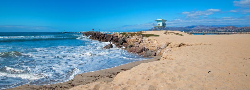 Lifeguard tower and rock jetty seawall in Ventura California U