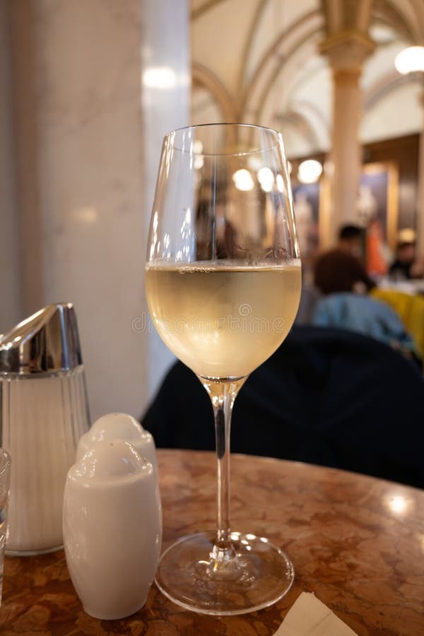 Lifestyle of beautiful Vienna, glass of cold white dry Austrian wine served in old Viennese-style cafe in Vienna, Austria stock image