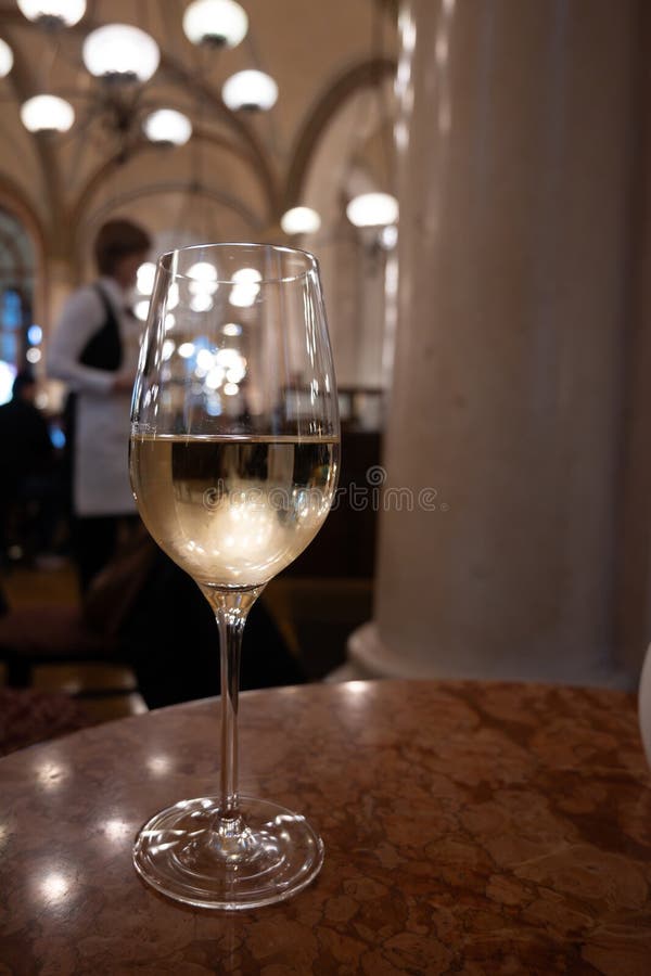 Lifestyle of beautiful Vienna, glass of cold white dry Austrian wine served in old Viennese-style cafe in Vienna, Austria stock photography