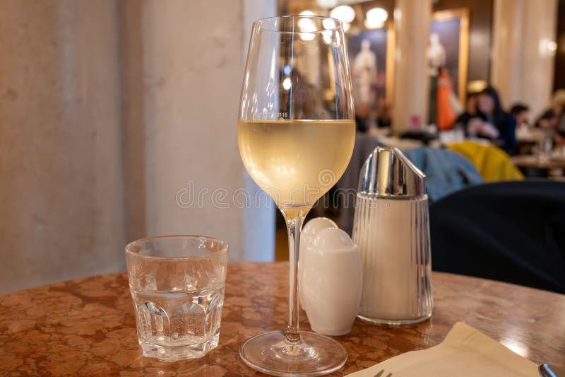 Lifestyle of beautiful Vienna, glass of cold white dry Austrian wine served in old Viennese-style cafe in Vienna, Austria stock images