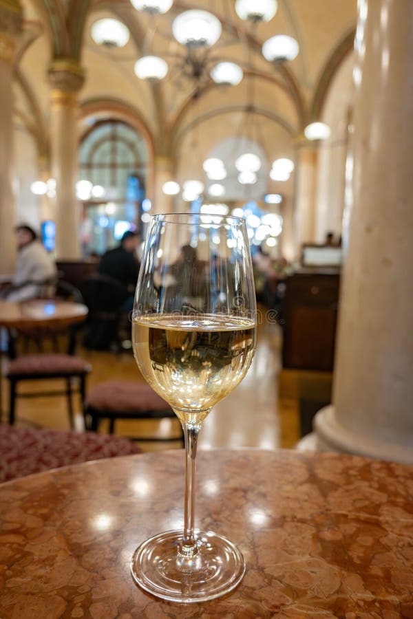 Lifestyle of beautiful Vienna, glass of cold white dry Austrian wine served in old Viennese-style cafe in Vienna, Austria stock photos