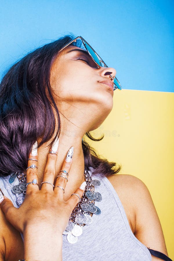 Lifestyle people concept. young pretty smiling indian girl with long nails wearing lot of jewelry rings, asian summer