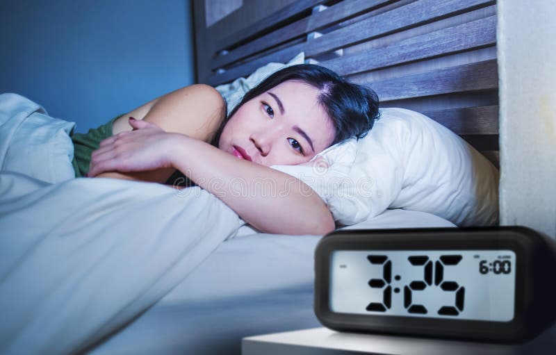Young pretty sad and depressed Asian Korean woman awake having insomnia disorder lying in bed sleepless suffering anxiety depressi stock image Young pretty sad and depressed Asian Korean woman awake having insomnia disorder lying in bed sleepless suffering anxiety depressi stock image