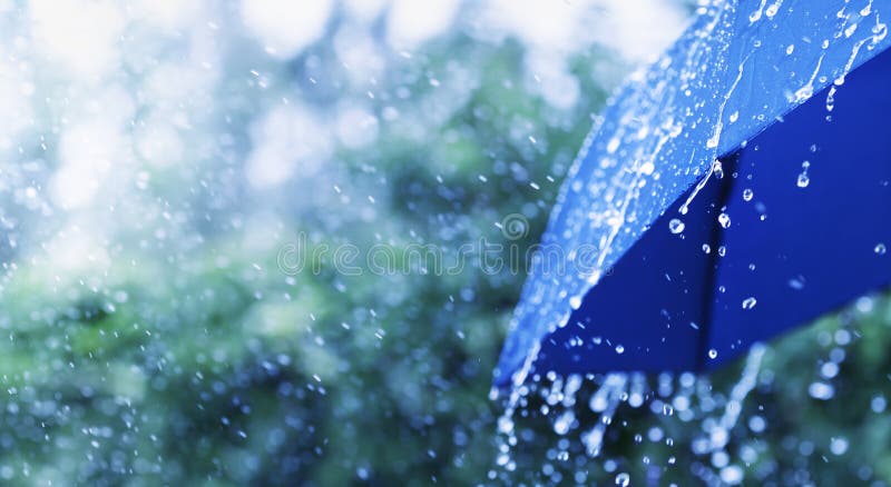 Lifestyle scene of rainy weather. Blue umbrella under rainfall. Banner format