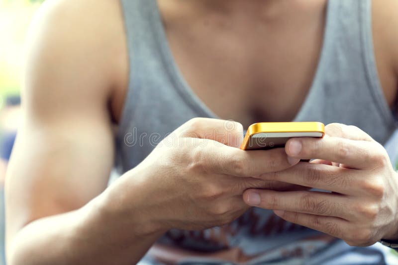 Lifestyle young man using a mobile phone with texting message royalty free stock images