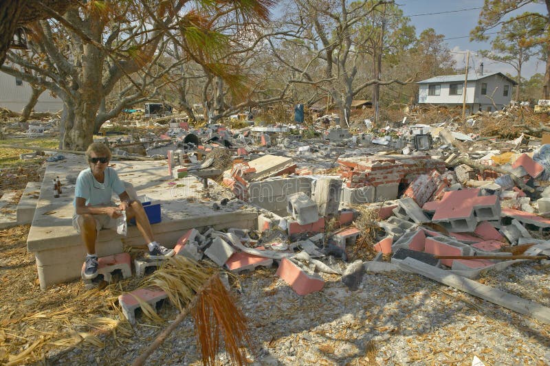 Lifetime woman resident surveying damage and debris in front of her house hit by Hurricane Ivan in Pensacola Florida