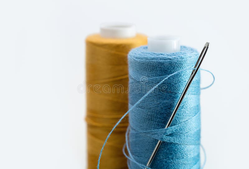 On Light Background, Coil of Yellow and Blue Threads, Needle in Coil ...