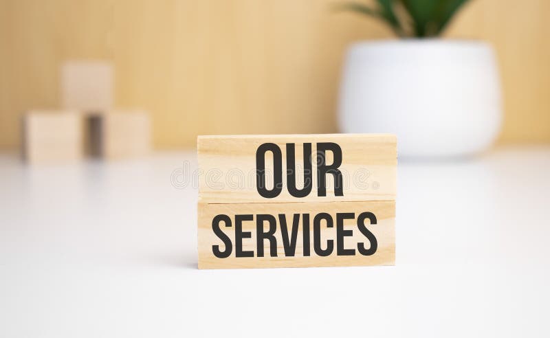On a light background, wooden cubes and a wooden block with the text our services. View from above