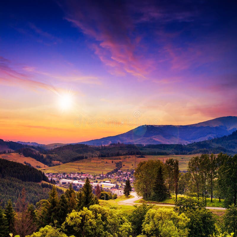 Light beam falls on hillside with autumn forest in mountain on