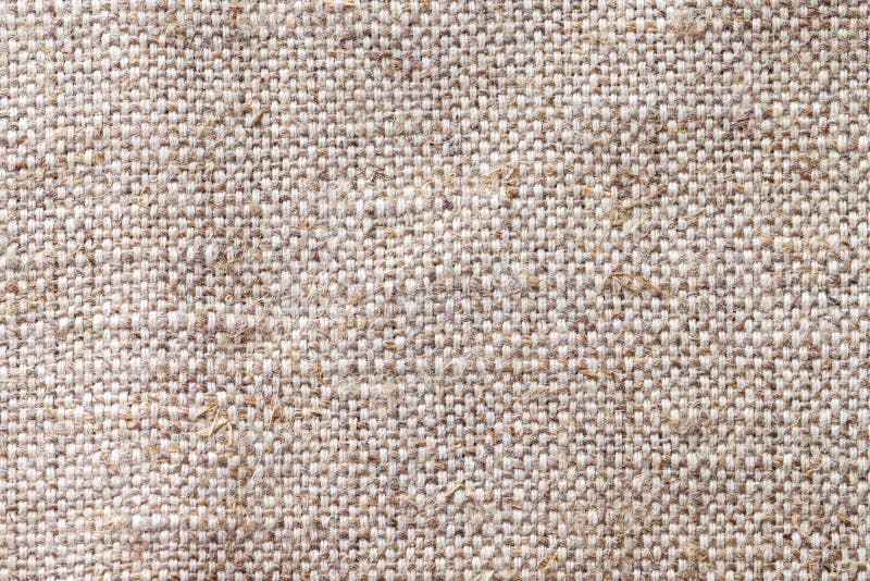 Light beige textile background closeup. Structure of the fabric macro
