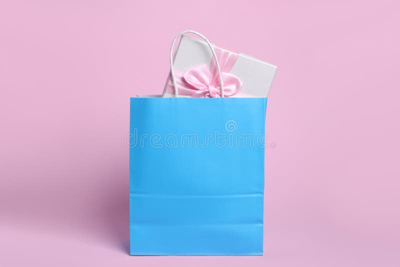 Light Blue Paper Shopping Bag with Gift Box on Pink Background Stock Photo Image of festive