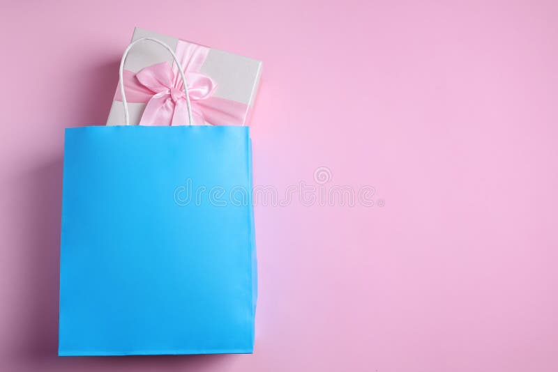 Light Blue Paper Shopping Bag with Gift Box on Pink Background, Top