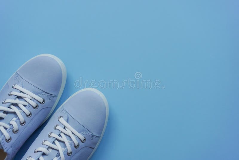 Light Blue Sneakers with White Laces and a White Sole on a Blue Flat ...