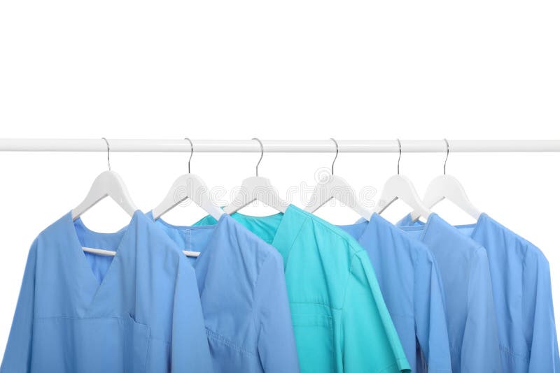 Light Blue and Turquoise Medical Uniforms on Rack Against White