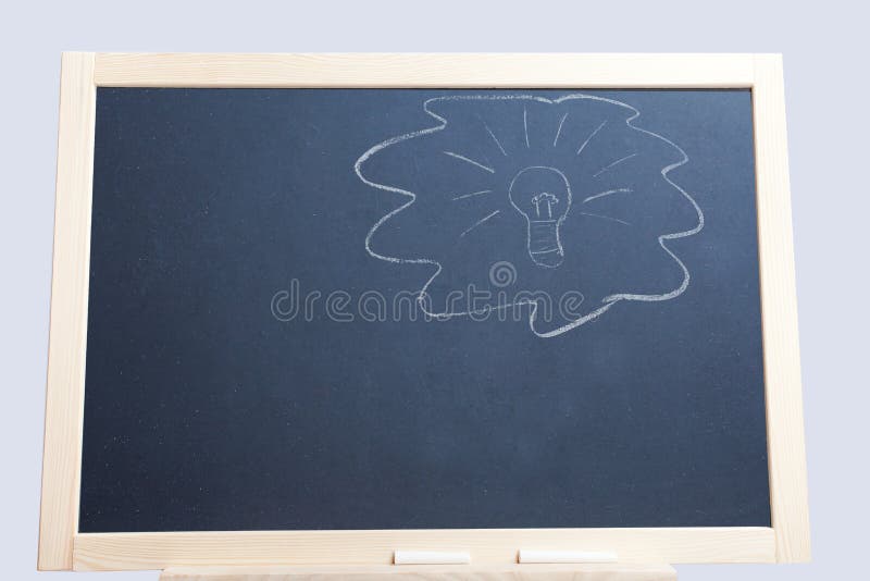 Light bulb on blackboard stock photo