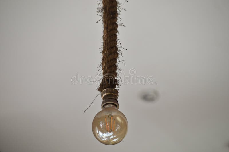 Light bulb on the rope stock photo. Image of exposed 172235102