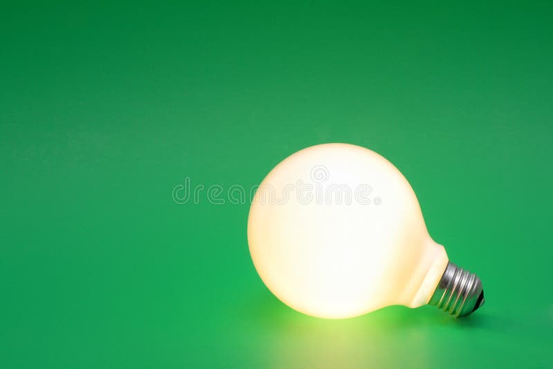 Light bulb on a green