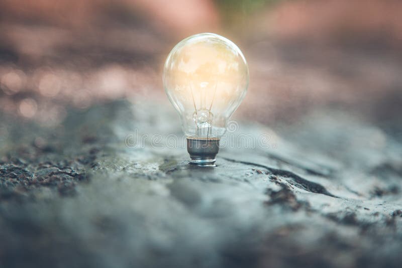 Light bulb on the ground stock photo. Image of symbol 211557338