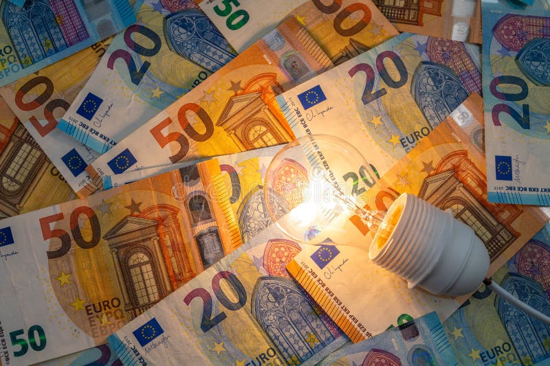 Light bulb on, on top of banknotes. royalty free stock photography