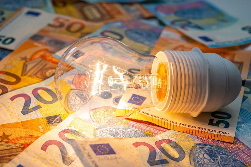 Light bulb on, on top of banknotes. stock photography
