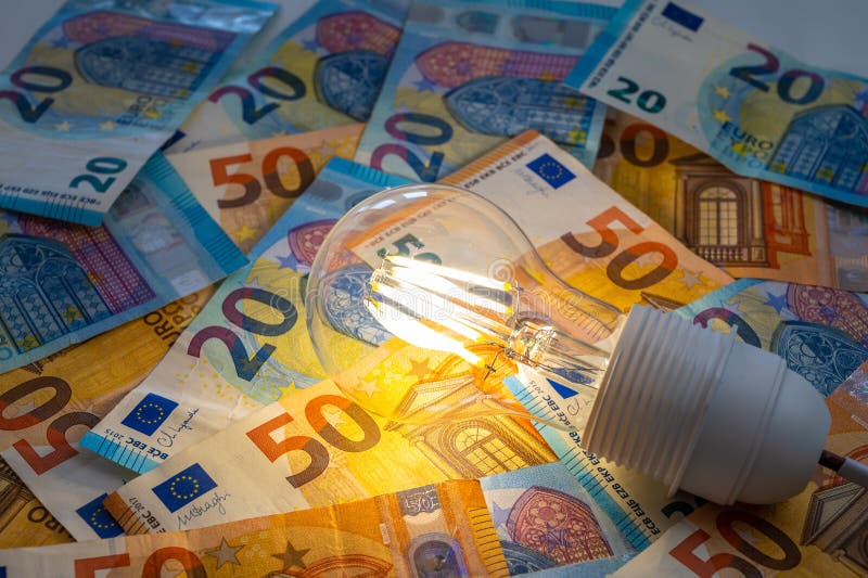 Light bulb on, on top of banknotes. royalty free stock photos