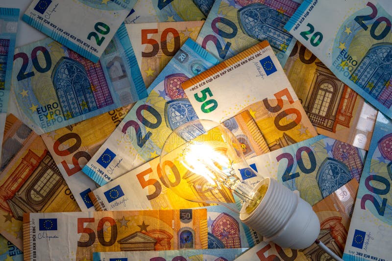 Light bulb on, on top of banknotes. stock photo