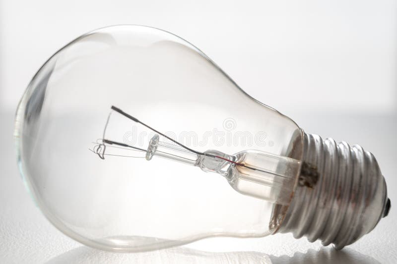 Light bulb on white surface. royalty free stock image
