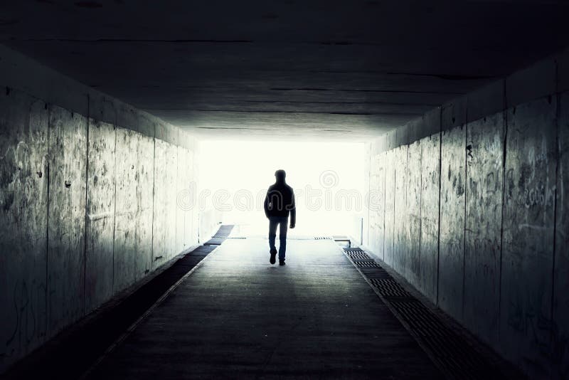 Silhouette in a subway tunnel. Light at End of Tunnel