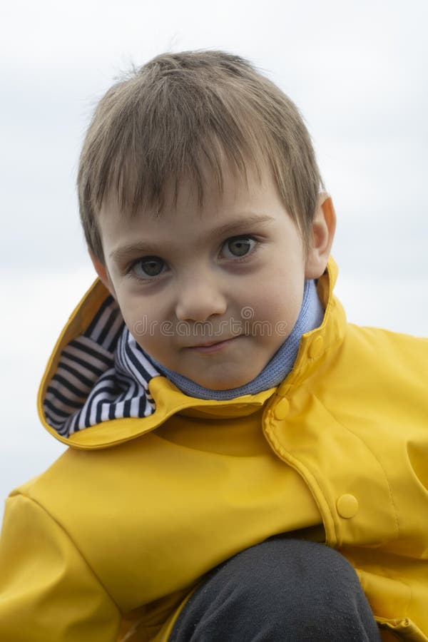 Blond Boy in a Yellow Jacket Close Up Stock Photo Image of face