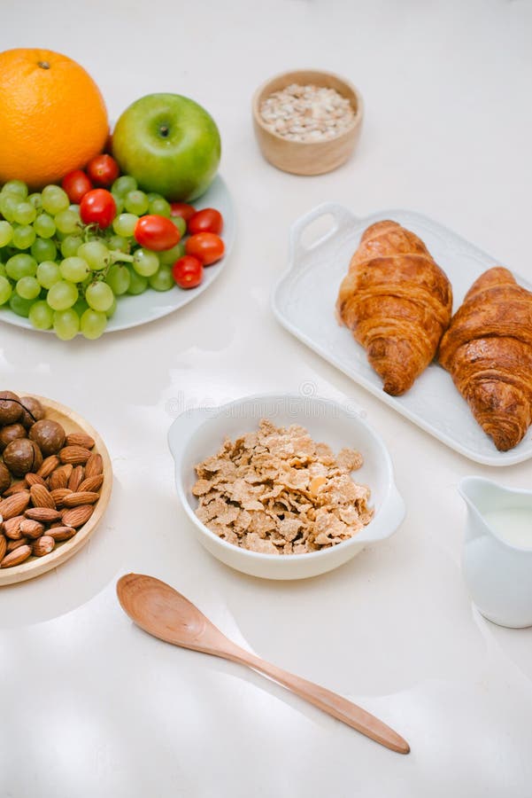 Light Healthy Breakfast with Oatmeal. Hercules, Nuts, Fruit, Boiled Eggs, Bread. Tableware