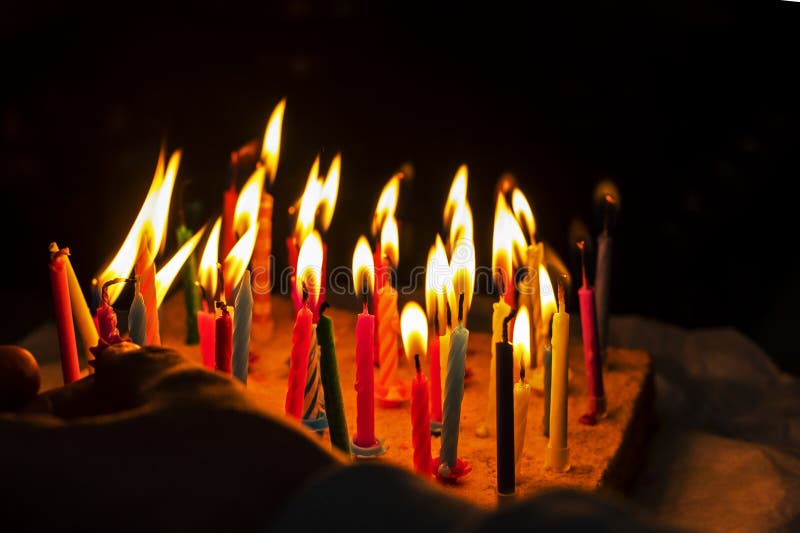 Light a Lot of Multicolored Candles on a Festive Anniversary Cake in