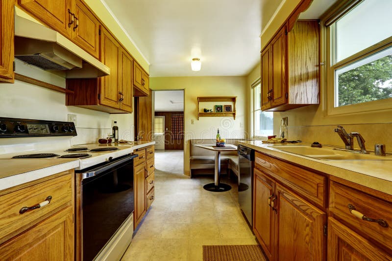 Light Narrow Kitchen Room with Corner Sofa and Small Table Stock Image