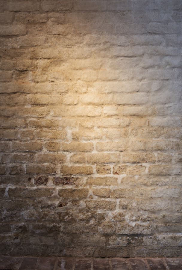 Light patch of light on the old plastered brick wall