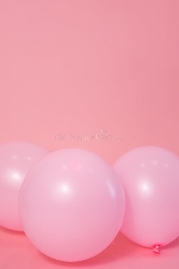 Light Pink Balloons on a Pink Backdrop with Copy Space for a Birthday