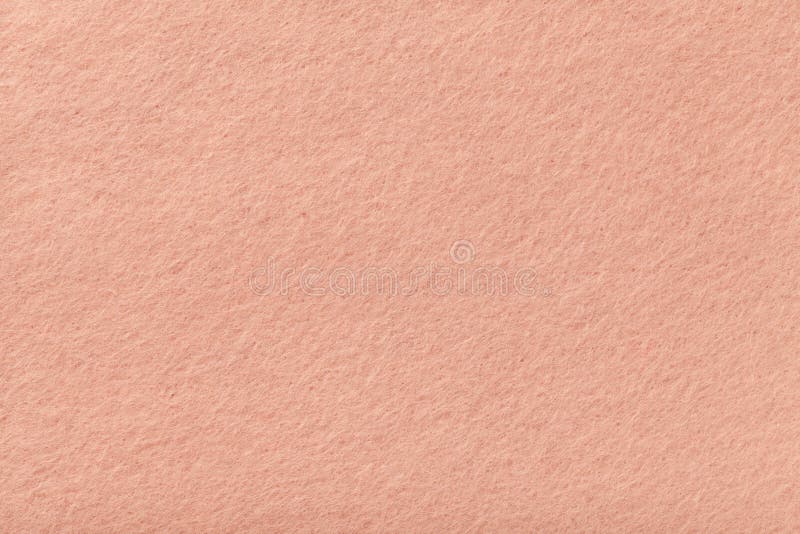 Light pink matt suede fabric closeup. Velvet texture of felt.