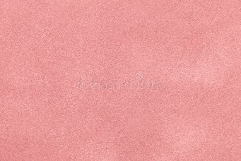 Pink matt suede fabric closeup. Velvet texture.