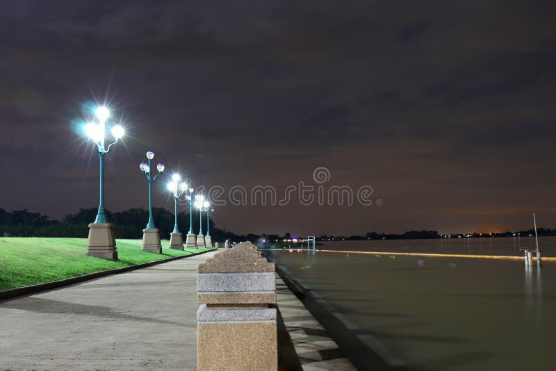 The light from a light pole at night in the park. at Riverwalk, lighting, seating, evening getaway landscape