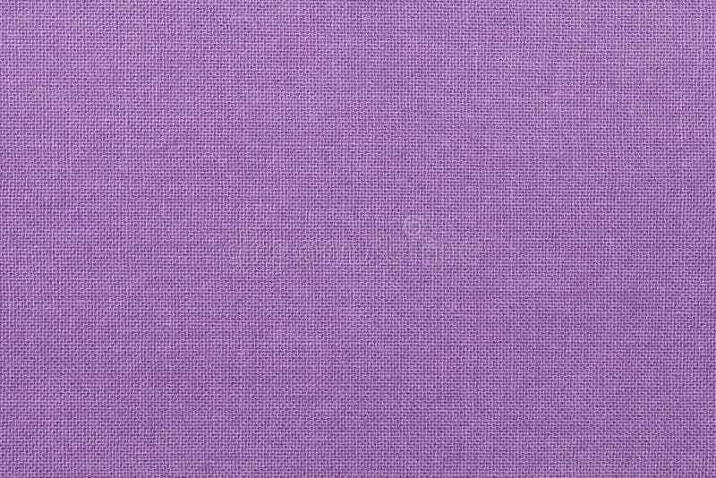Light purple background from a textile material. Fabric with natural texture. Backdrop. stock image