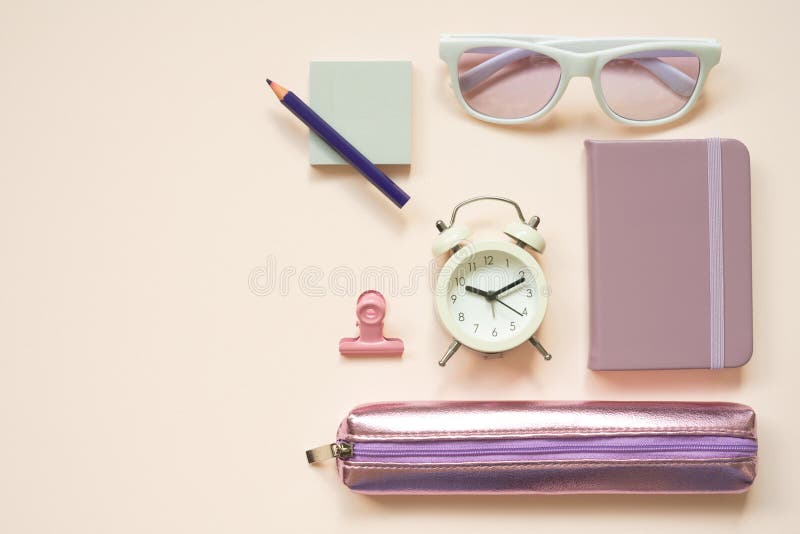 Light purple office supply stationery on pink desk background. flat lay, top view. studio shot
