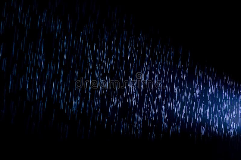 Light Ray from a Spotlight on Raindrops during a Dark Rainy Night Stock Photo Image of glowing