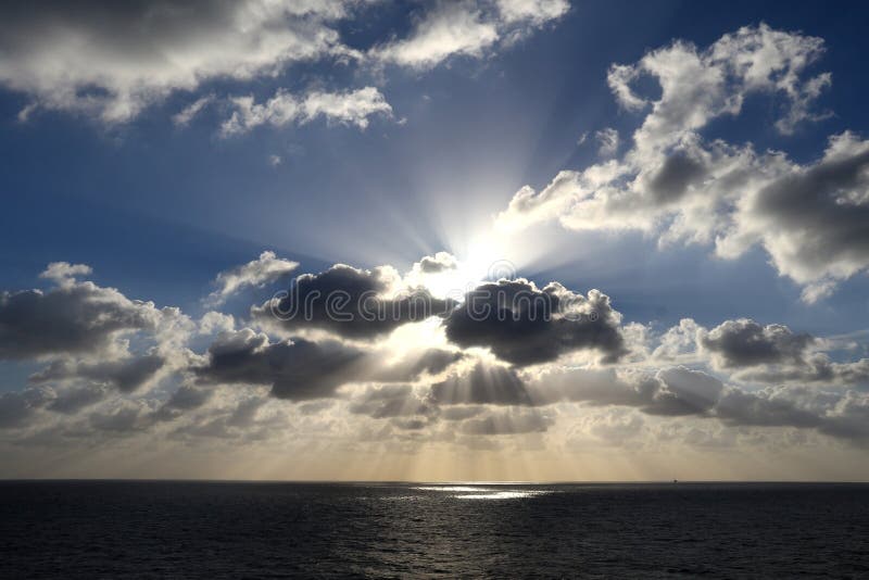 Light rays shine through the group of clouds