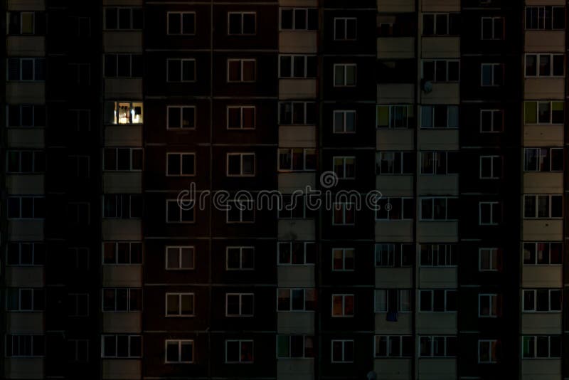 Light in a single window. Flat night panorama of multicolor light in windows of multistory buildings. life in big city.